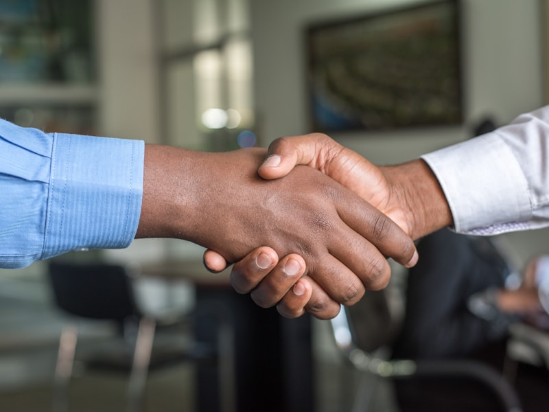 Two people shaking hands in an office