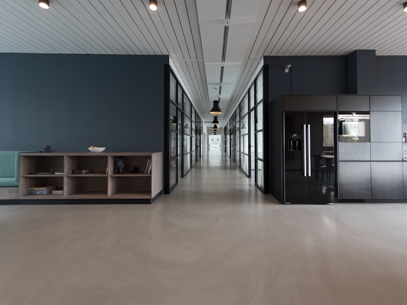 An empty corridor in a modern office with a polished concrete floor
